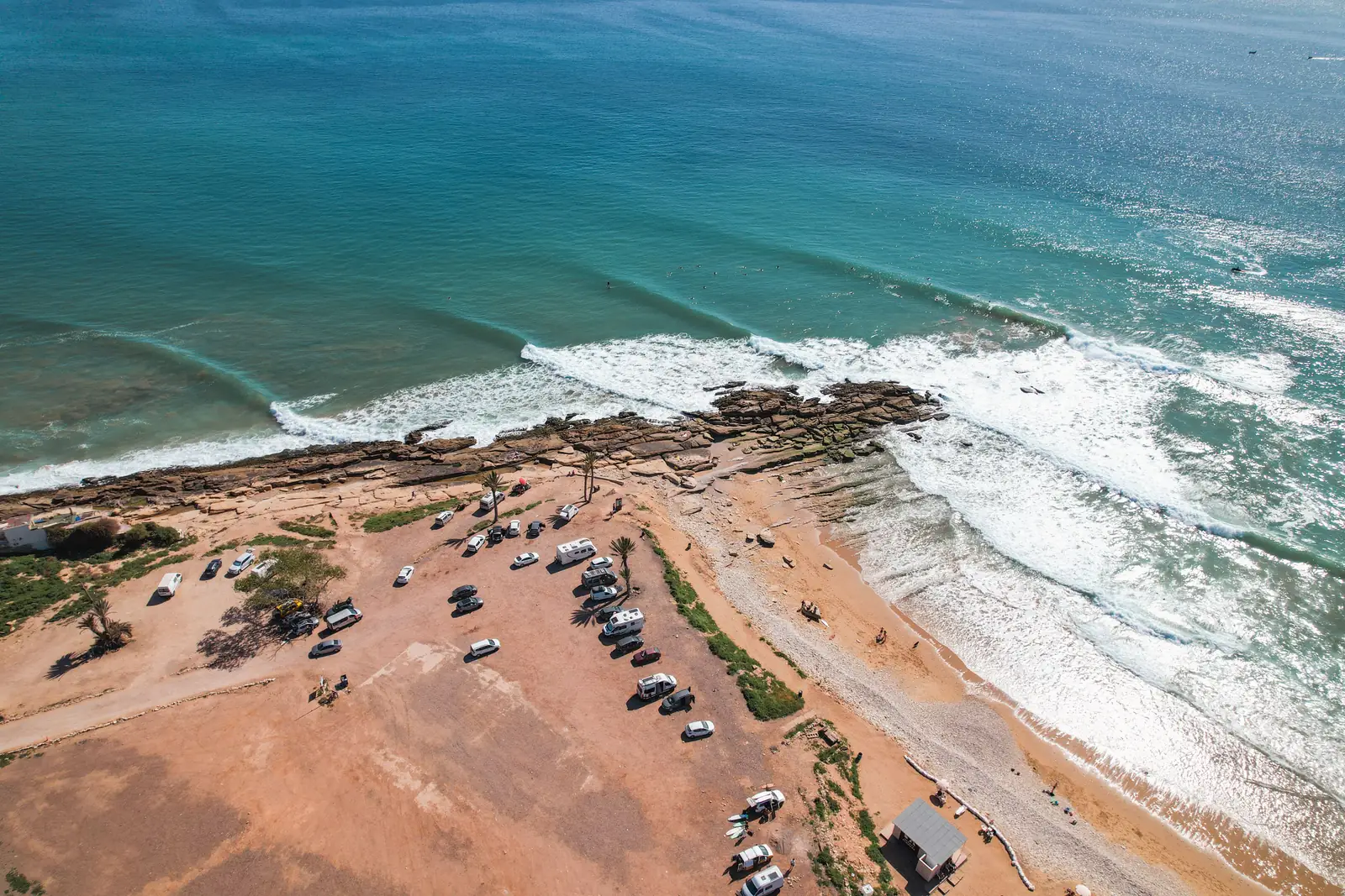 Aerial view of the Atlantic coast at Taghazout, near Agadir, with cars parked facing the ocean